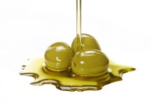 Olives with olive oil pouring over them